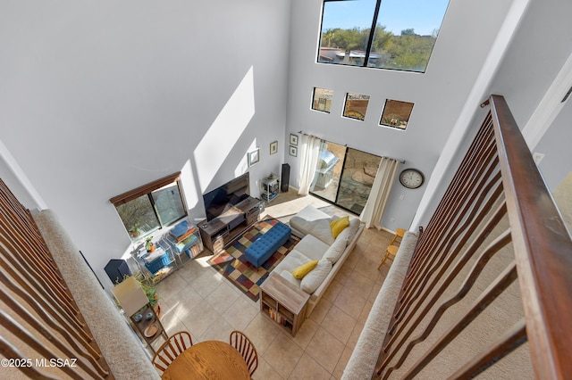 tiled living room with a high ceiling