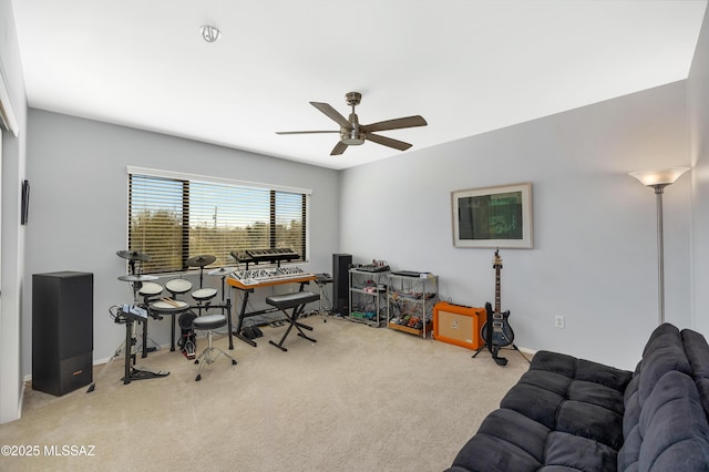 carpeted home office featuring ceiling fan