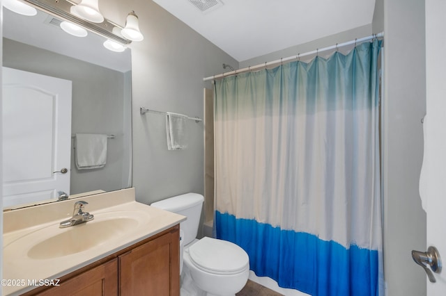 bathroom with toilet, walk in shower, and vanity