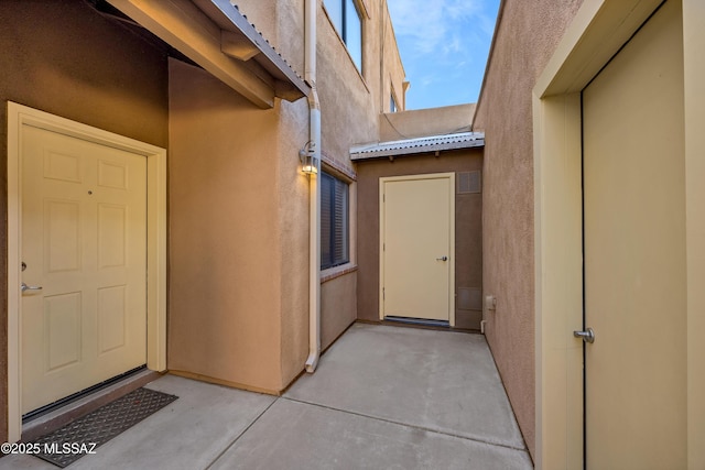 view of exterior entry with a patio