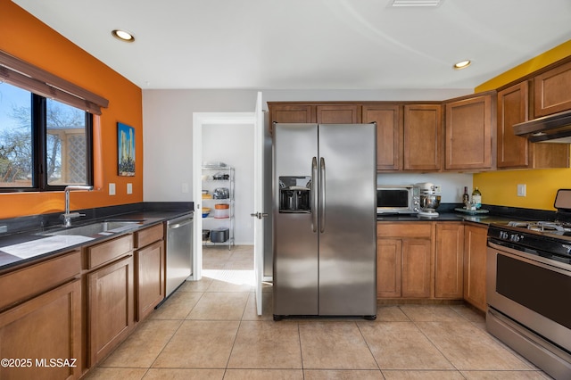 kitchen with light tile patterned floors, sink, and appliances with stainless steel finishes