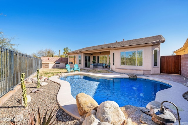 view of swimming pool with ceiling fan, an outdoor hangout area, and a patio