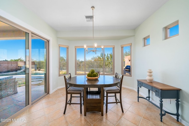 dining space with light tile patterned floors and a chandelier