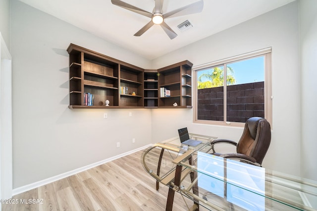 office area with ceiling fan, light hardwood / wood-style flooring, and built in desk