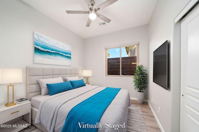 bedroom featuring ceiling fan, light hardwood / wood-style floors, and a closet