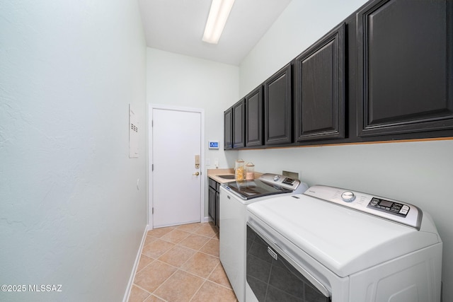 clothes washing area with cabinets, light tile patterned flooring, and separate washer and dryer