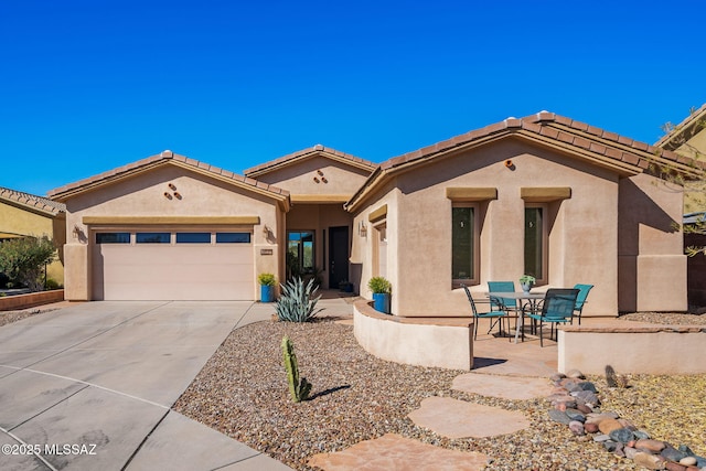 view of front of home featuring a garage and a patio area