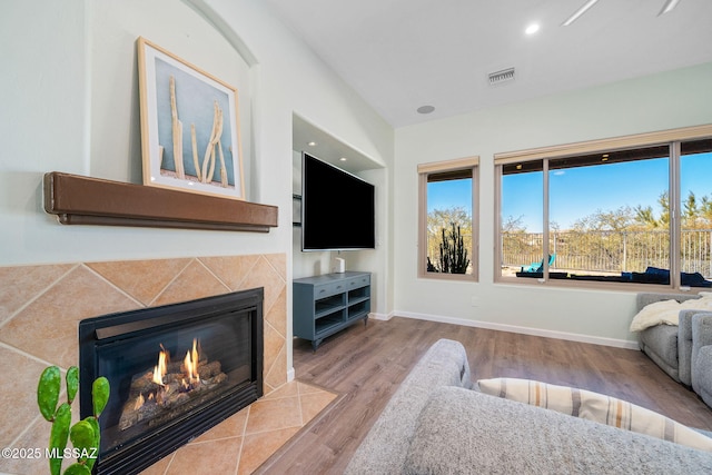 living room featuring a fireplace and light hardwood / wood-style flooring