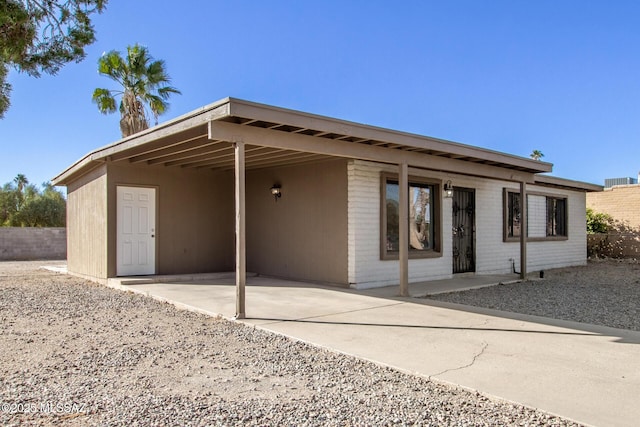 rear view of property with a carport