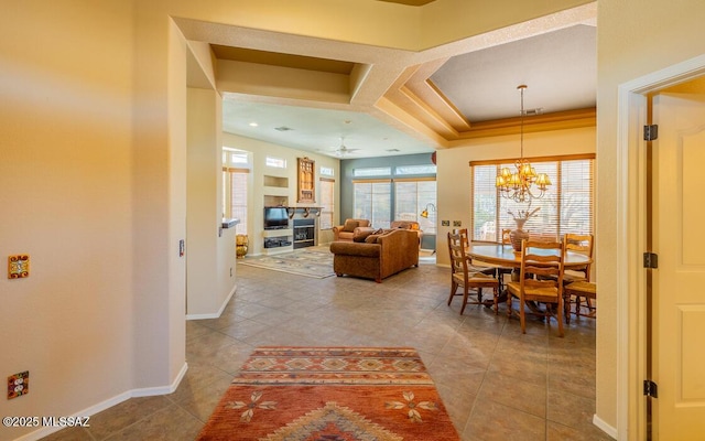 dining area with ceiling fan with notable chandelier and light tile patterned floors