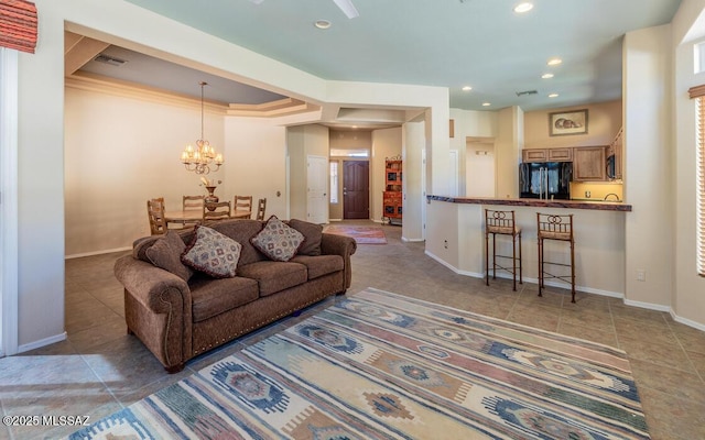 living room with a chandelier, crown molding, and tile patterned flooring