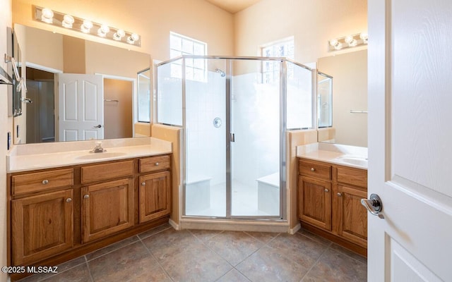 bathroom with vanity and a shower with door