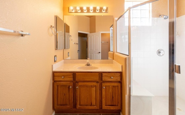 bathroom featuring vanity and an enclosed shower