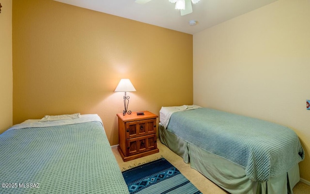 bedroom with ceiling fan and carpet floors