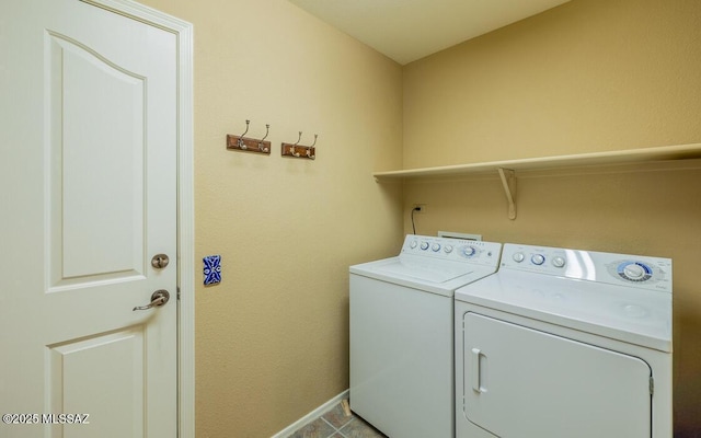 washroom with light tile patterned flooring and washer and dryer