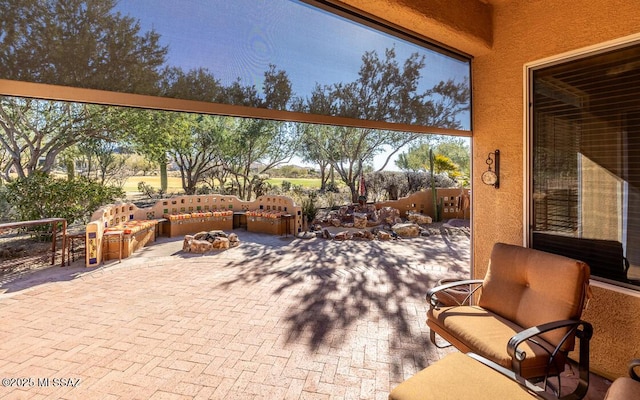 view of patio with an outdoor living space with a fire pit