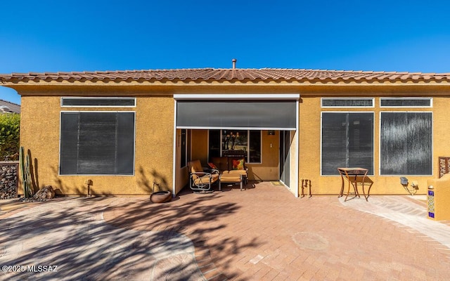 back of house with a patio