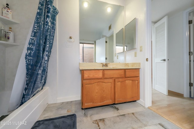 bathroom with hardwood / wood-style floors, shower / tub combo with curtain, and vanity