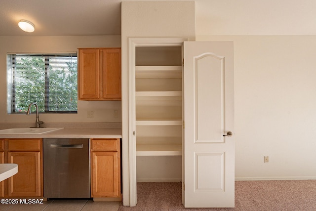 kitchen with dishwasher, light carpet, and sink