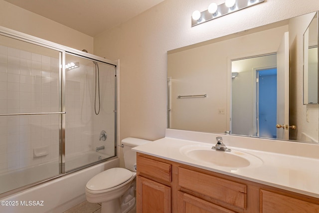 full bathroom with toilet, vanity, and shower / bath combination with glass door