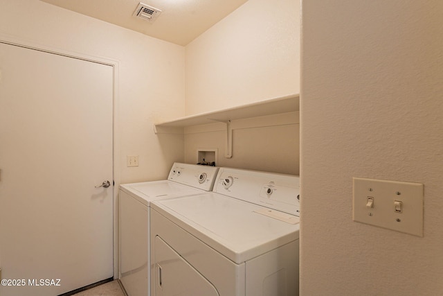 clothes washing area featuring independent washer and dryer