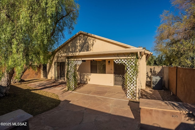 back of property with a patio and central AC unit