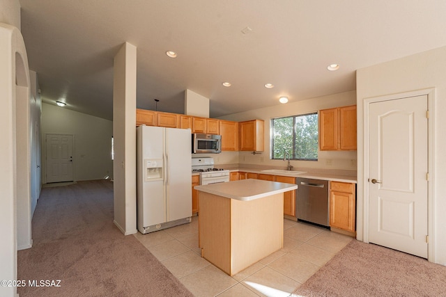 kitchen with stainless steel appliances, a kitchen island, light tile patterned flooring, and vaulted ceiling