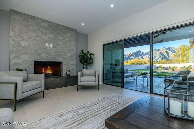 living room with a mountain view and a stone fireplace