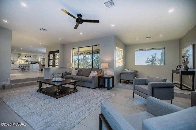 tiled living room with ceiling fan