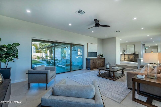 living room featuring light tile patterned floors and ceiling fan