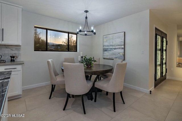 tiled dining area featuring a notable chandelier