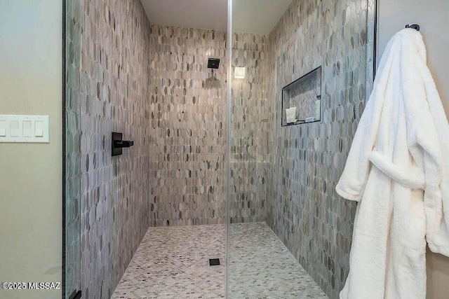 bathroom with tiled shower