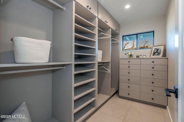 walk in closet featuring light tile patterned floors