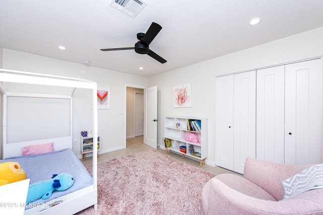 bedroom featuring a closet, light tile patterned floors, and ceiling fan