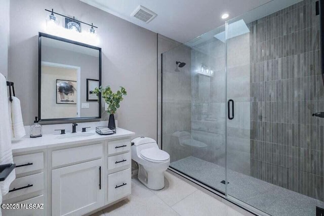 bathroom with a shower with shower door, toilet, vanity, and tile patterned flooring