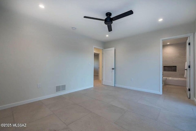 unfurnished bedroom with ceiling fan, connected bathroom, and light tile patterned floors