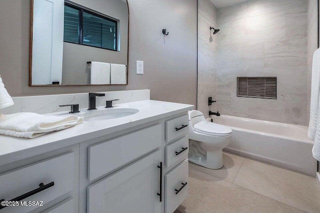 full bathroom with vanity, toilet, tiled shower / bath, and tile patterned flooring