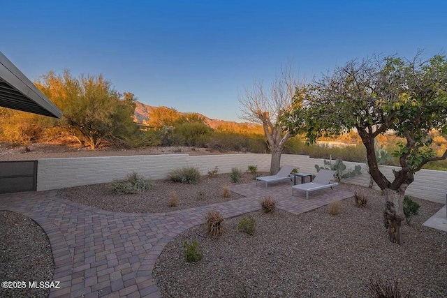 view of yard with a mountain view and a patio