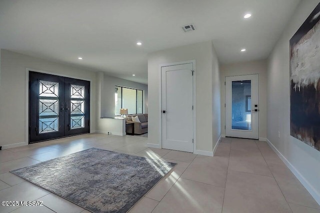 tiled entrance foyer featuring french doors