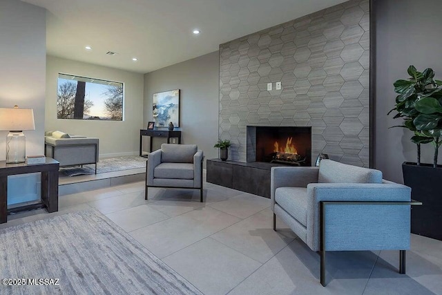 living room featuring a fireplace and light tile patterned floors