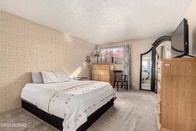 bedroom featuring brick wall, light colored carpet, and a textured ceiling