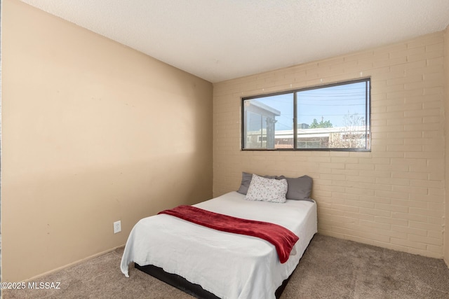 bedroom with brick wall and light carpet