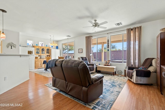 living room with light hardwood / wood-style floors and ceiling fan