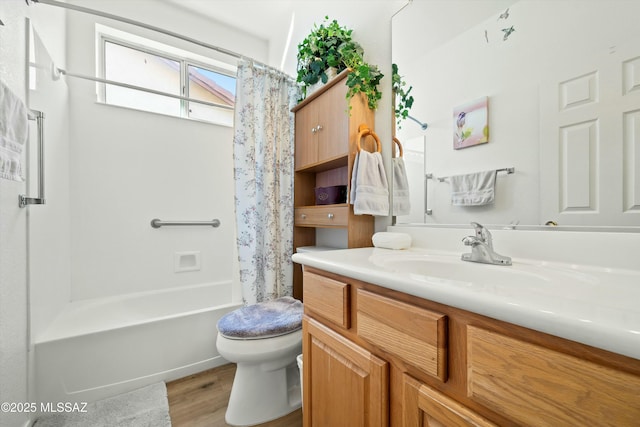 full bathroom featuring vanity, hardwood / wood-style floors, shower / tub combo, and toilet