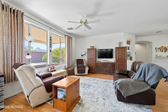 living room featuring ceiling fan and light hardwood / wood-style flooring