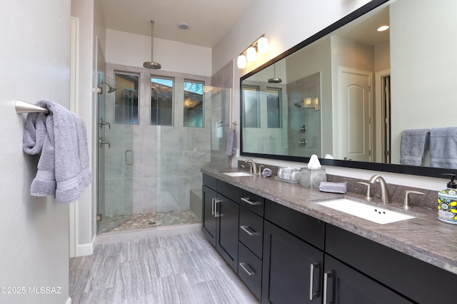 bathroom featuring walk in shower and vanity