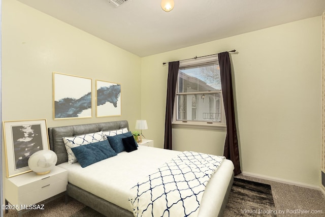 bedroom with dark colored carpet