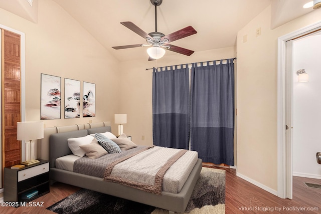 bedroom with ceiling fan, vaulted ceiling, and hardwood / wood-style floors