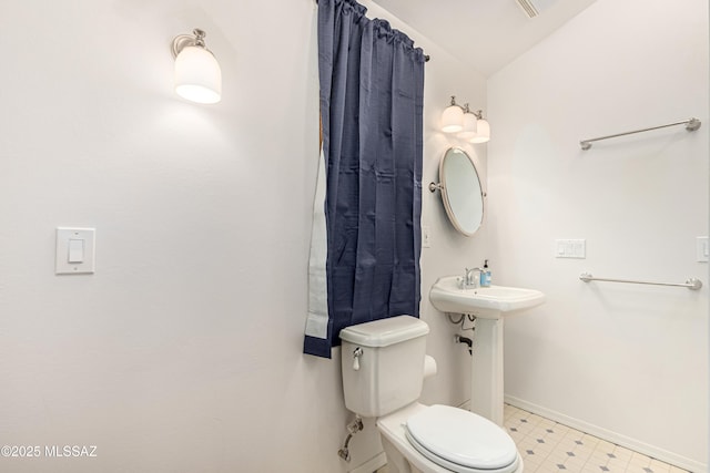 bathroom featuring vaulted ceiling and toilet