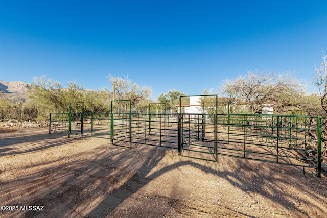 view of horse barn with a rural view